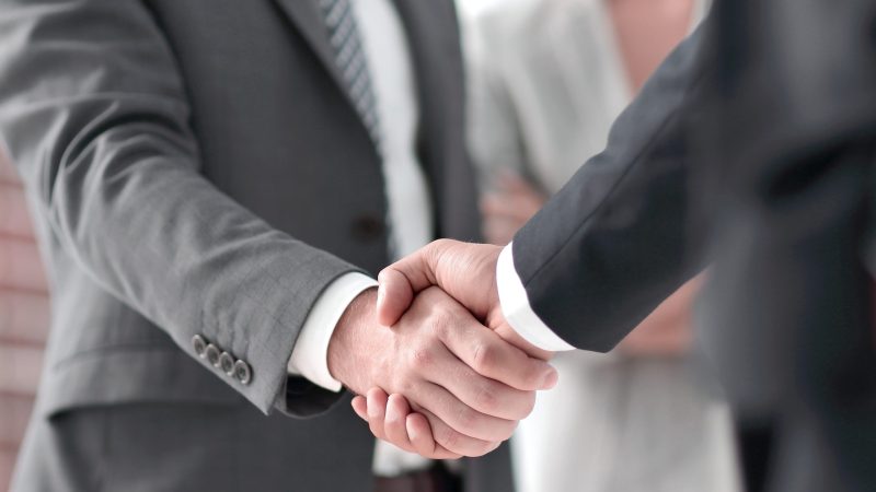closeup-handshake-business-partners-scaled.jpg